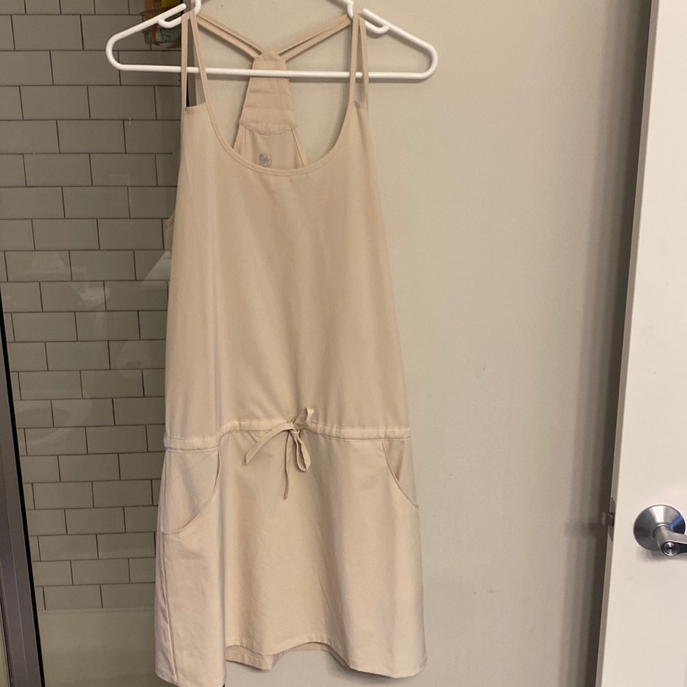 Cream razorback dress with pockets. Athletic material